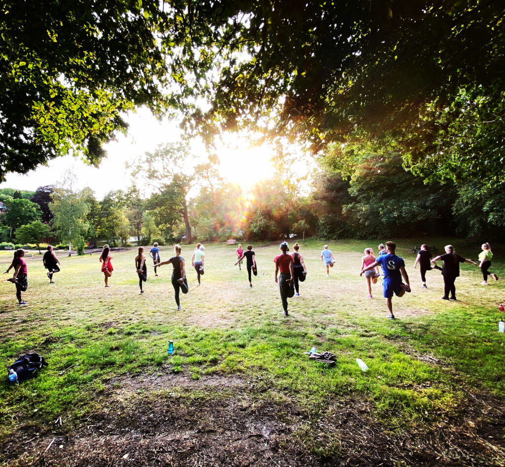 A Drum n Bounce class in the park as the summer sun sets in the background. 